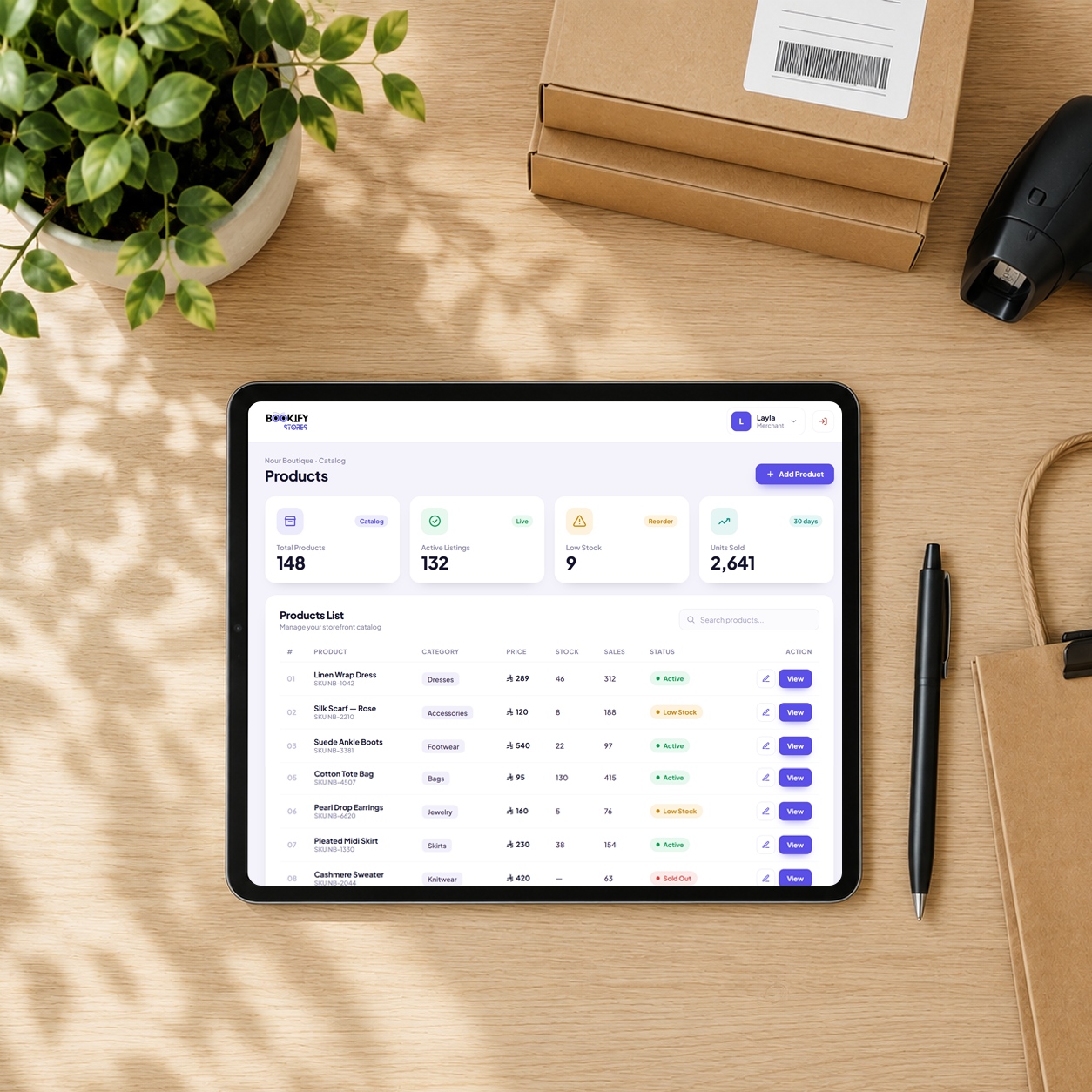 A tablet on a desk showing the Bookify Stores merchant products dashboard